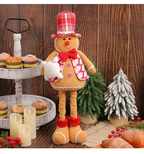 Close-up of a gingerbread doll with a chef hat and red bowtie in a cozy Christmas setting