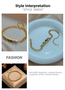 Detail of gold chain bracelet featuring vibrant rectangular rainbow gemstones with lobster clasp