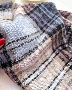Close-up of soft plaid cashmere-like fabric weave in blue, pink and beige tones