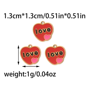 Macro shot of red heart pendants with love engraving and pink detail showing 1.3cm size