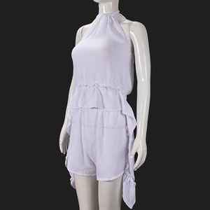Close-up of white halter neck top and shorts set showing breathable wrinkled cotton fabric