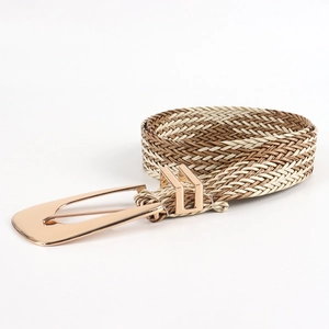 Close-up of golden irregular metal buckle and multi-color woven straw belt texture