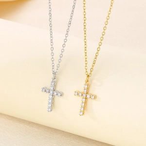 Detailed view of silver and gold cross necklaces featuring micro-paved cubic zirconia