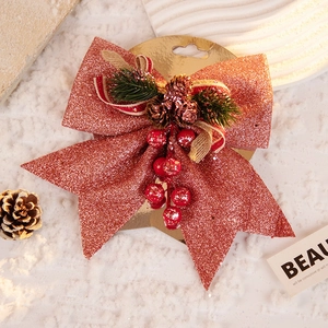 Red glitter Christmas bow with pine cones and red berries for festive tree decoration