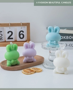 Group of colorful bunny scented candles in green, purple, blue, and white with bows
