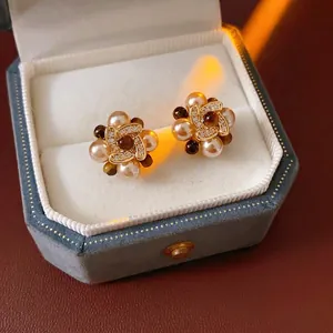 Vintage flower earrings with pearls and tiger eye stones on blue velvet box