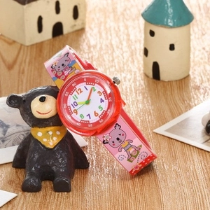 Waterproof children quartz watch with pink koala print strap and red case on wooden surface