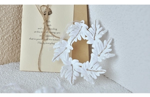 Macro detail of leaf-shaped acrylic wreath pendant with sparkling gold glitter accents