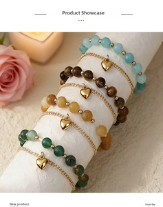 Detail view of multi-layer magnetic couple bracelets with semi-precious beads and gold hearts