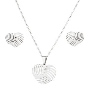 Detail shot of heart-shaped swirl necklace and earrings set in polished silver finish