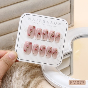 Handmade strawberry press-on nails with cat eye shimmer and sweet hand-painted designs