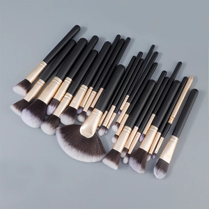 Close-up of 24-piece professional black and gold makeup brush set with gradient bristles