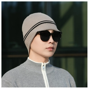 Detail of grey winter knit beanie with black stripes and thick thermal texture fabric