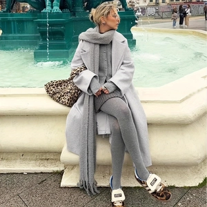 Street style view of high-quality grey vertical striped cotton leggings with coat