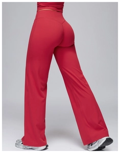 Detail view of red high-waisted yoga pants showing V-shaped waist design and loose fit