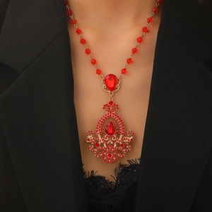 Luxurious vintage bohemian necklace with red crystal pendant on a gold alloy base
