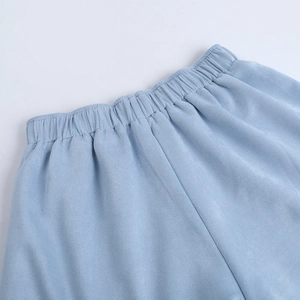 Detail of light blue shorts showing elastic waistband and brushed faux suede texture