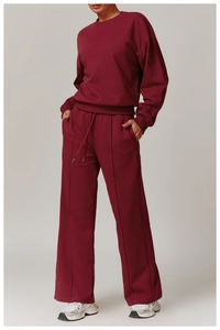 Detail of high-waist burgundy tracksuit with drawstring and vertical seam joggers