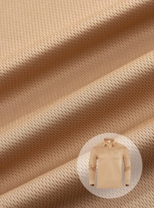 Close-up of camel brown breathable piqué fabric texture and chest pocket on long sleeve polo