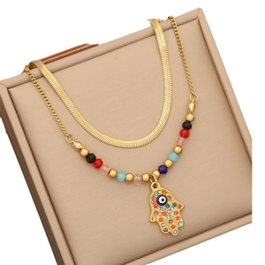 Double layer gold snake chain necklace with Fatima hand and evil eye pendant on jewelry box