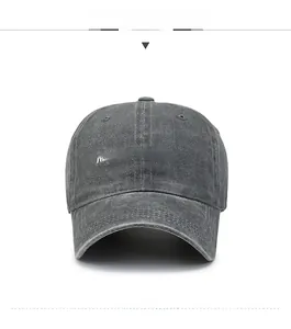 Detailed front view of a grey washed denim baseball cap with happy-headache embroidery