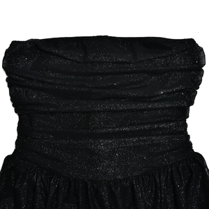 Close-up of black mesh fabric with glitter and ruching on a strapless dress