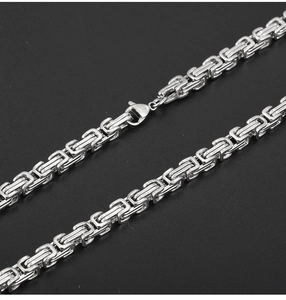 Detailed macro view of a 5mm silver stainless steel Byzantine chain with lobster clasp