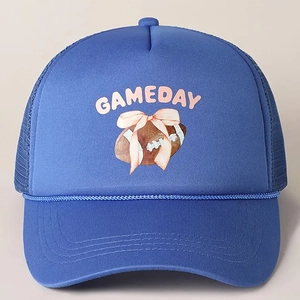 Close-up of royal blue trucker hat with pink GAMEDAY text and rugby pattern details