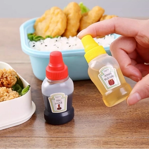 Close-up of mini portable sauce squeeze bottles for soy sauce and mustard in a lunch box