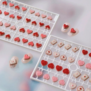 3D resin heart nail charms in pink and red shades with embossed sweet heart text