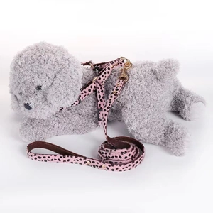 Pink leopard print pet harness and leash set with metal hook on a plush dog model