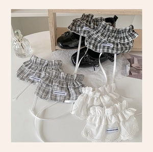 Lace ruffle ankle cuffs with black and white plaid patterns paired with Mary Jane shoes