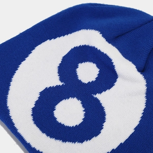 Detail of royal blue knitted beanie featuring a white jacquard number eight pattern