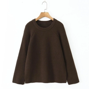Detailed view of dark brown knitted sweater featuring vertical ribbed texture on the fabric