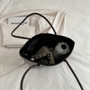 Minimalist dark brown leather tote bag with a spacious interior for daily essentials