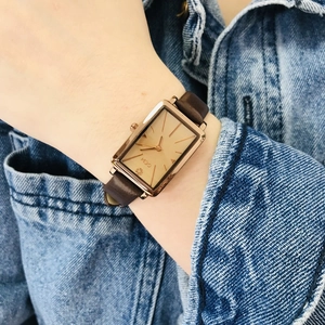 Women's rectangular rose gold watch with champagne dial and dark brown leather strap
