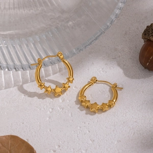 Elegant 18K gold plated stainless steel star hoop earrings on a decorative tray