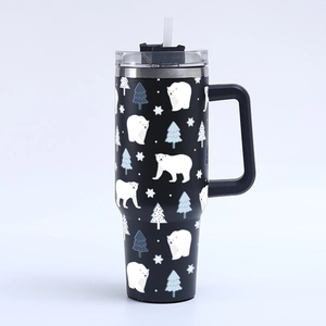 Detail of 40oz black tumbler with white polar bear and snowflake winter pattern