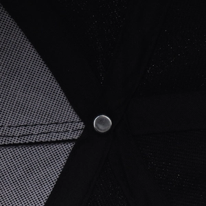 Detail of internal crown stitching with metal rivet on black and white mesh baseball cap