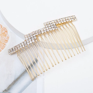 Elegant gold metal hair comb with sparkling rhinestones and pearls on white background