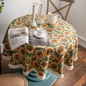 Thick round sunflower tablecloth with cream tassels in a cozy home setting