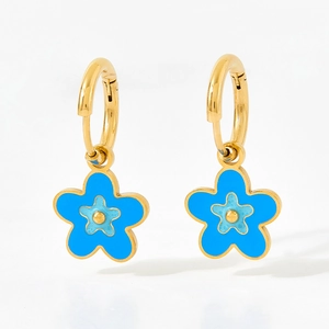 Élégantes boucles d'oreilles dorées avec pendentifs fleurs en émail bleu sur fond blanc