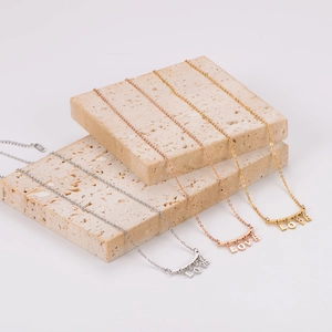Elegant LOVE letter pendant necklace set in gold, rose gold and silver on stone