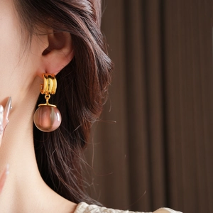 Detail view of irregular resin pendant earring on model showing elegant drape and pink bead