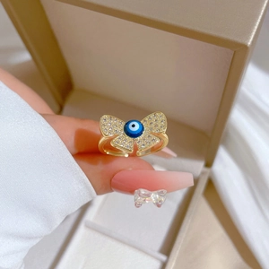 Adjustable gold butterfly ring with blue evil eye stone and white zircon accents