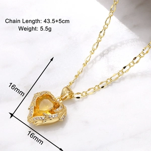 Macro view of gold heart pendant with yellow gemstone and detailed size measurements