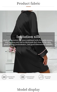Detail of black imitation silk robe with smooth satin texture and pink trimmed cuffs