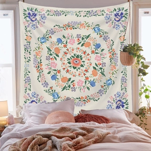 Close-up of floral mandala tapestry featuring roses and colorful patterns on a bedroom wall