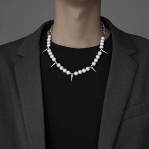 Hip-hop reflective pearl and titanium steel spike necklace for men on a grey suit model