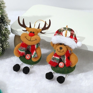 Christmas plush ornaments featuring reindeer and bear with red-green scarves on white rug